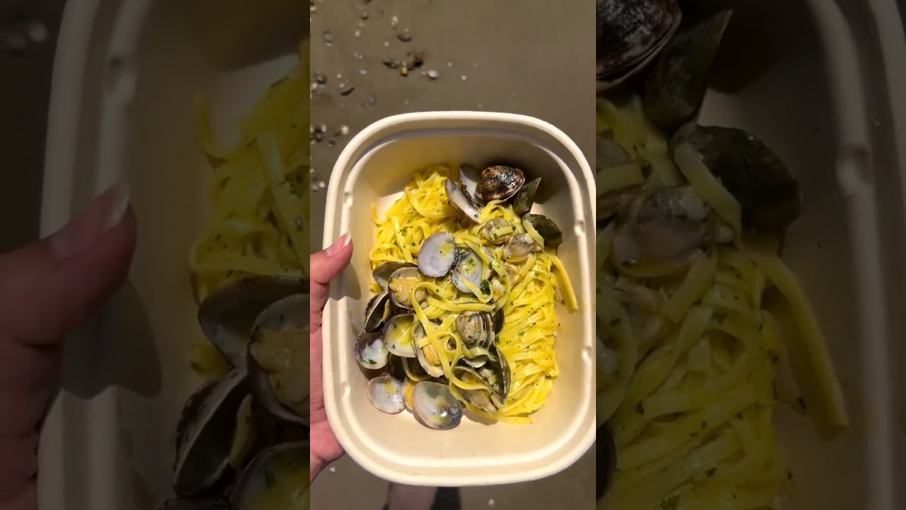 Linguine alle vongole on a beach in Tuscany, Italy