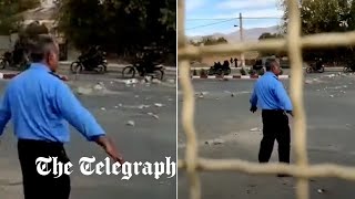 University security guards protect students in Sanandaj as Iranian security forces fire shots