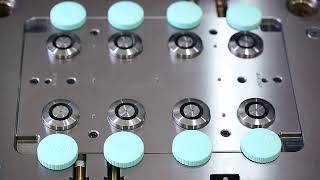 Multi-cavity plastic injection mold with unscrewing unit