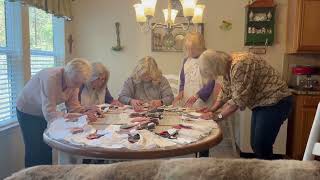 Angels In Waiting 91:4 praying over tiny Angel Gowns.