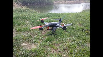 Custom JJRC X1 - acro flying over a river and trees