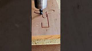 Router hums, bit carves, wood breathes into quiet rhythm of precise groove
