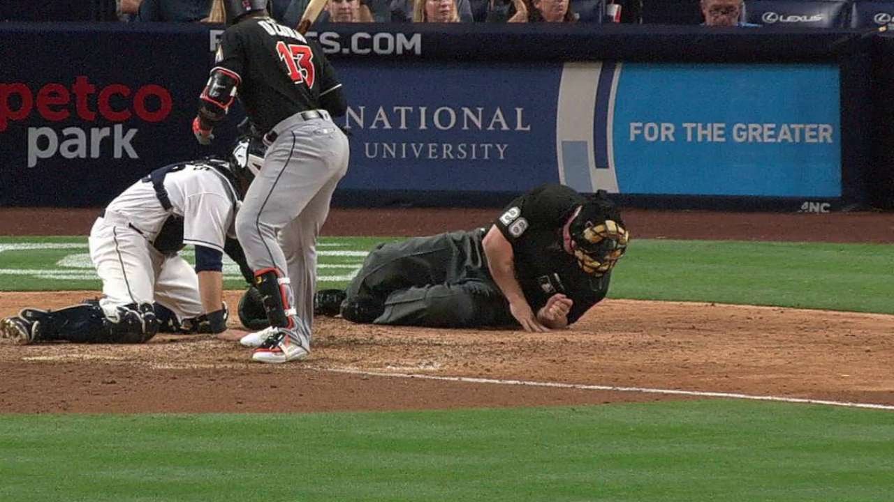 MIA@SD: Home-plate umpire shaken up after being hit