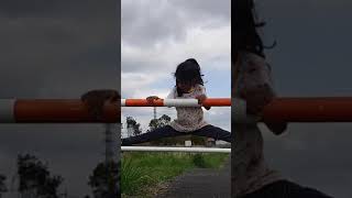 A Little Girl Is Training The Split On The Road 