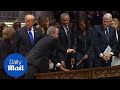 George w bush gives michelle obama candy at fathers funeral
