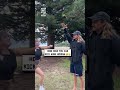 She aims for his hand then kicks him in the nuts