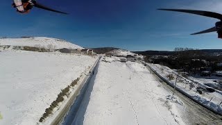 quadcopter flight over snow covered hill