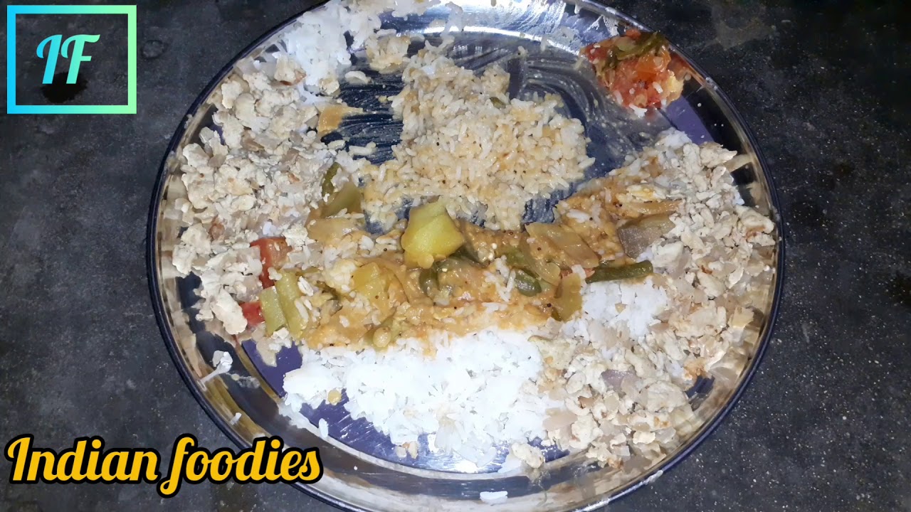 Indian foodie eating rice with sambar side dish poricha muttai fried egg curry