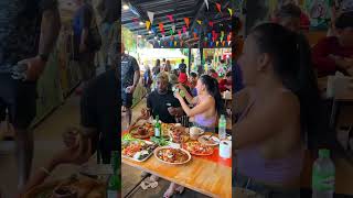 Thai girl and African man eat and display Isaan food - Thai Street Food