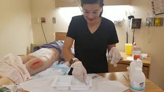 Wound Irrigation and packing with sterile forceps and Q-tips