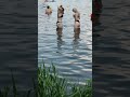 Reflections of girls in the water of the lake