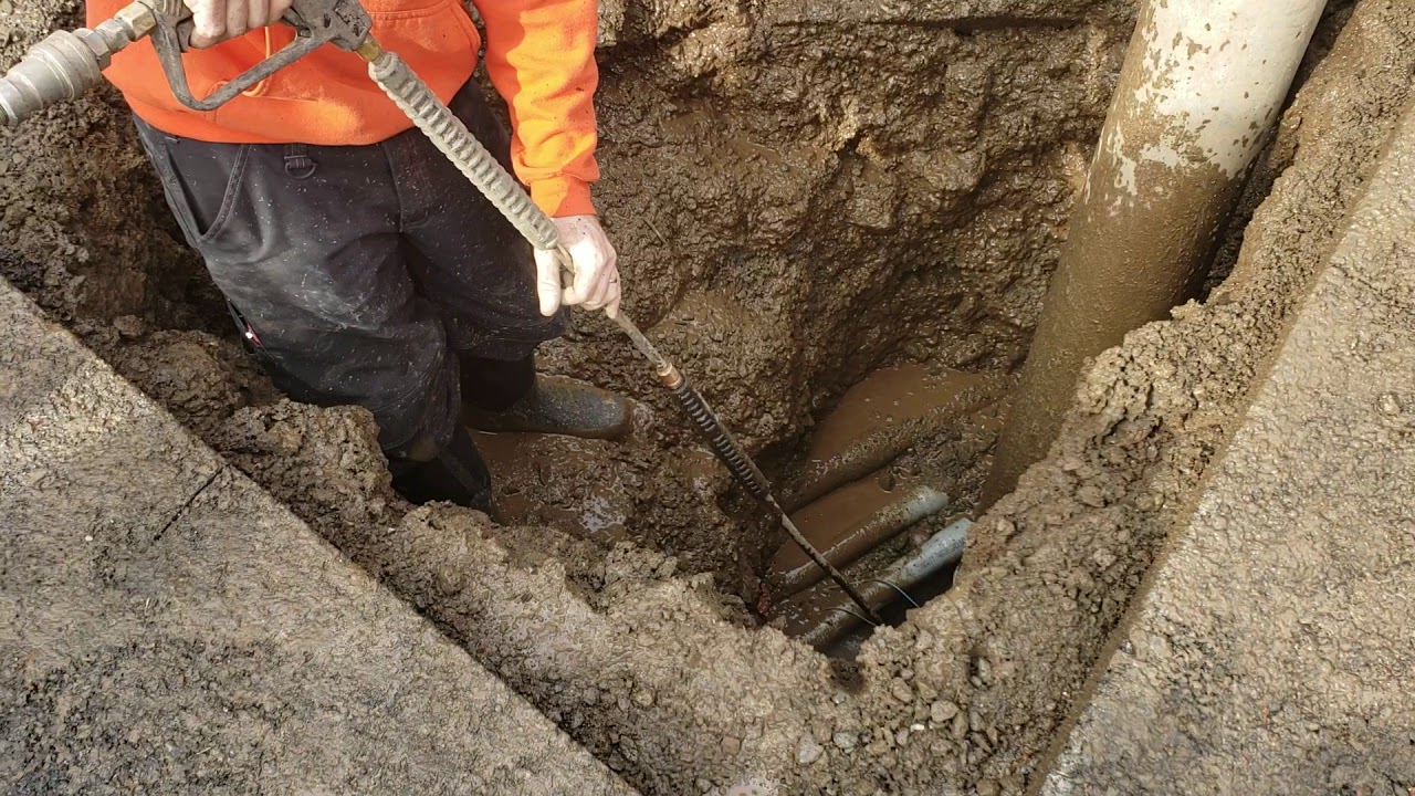 Hydro excavating down around utilities to get to broken water line