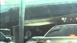 Truck knocks down light signal and sign pole onto traffic