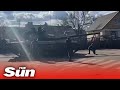 Fearless Ukrainian man kneels in front of marauding Russian convoy in Tiananmen tank moment