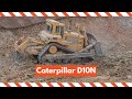 Caterpillar D10N bulldozer ripping rock and pushing material