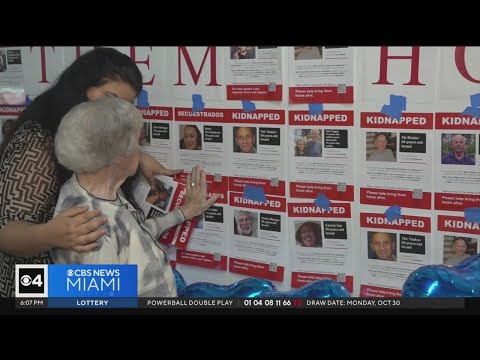 Holocaust survivors hang up posters of those kidnapped by Hamas at Dania Beach Holocaust Center