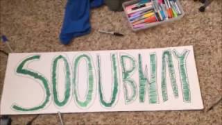 holding a sooubway sign in front of subway for theodd1sout