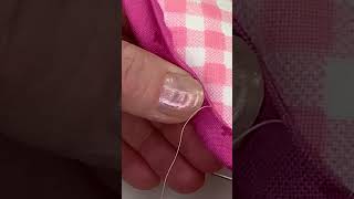 Hand stitching the binding on a mug rug