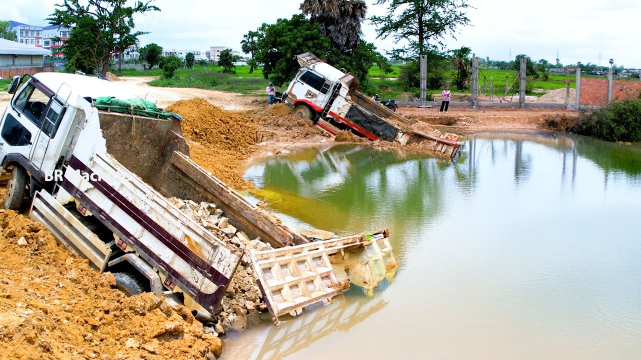 Pathetic truck owner the truck fall in the pond because over reverse and rescue by bulldozer and ex