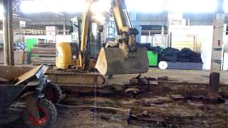 Cat 305CCR loading Bobcat Hopper