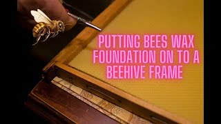 Putting bees wax foundation on to beehive frames