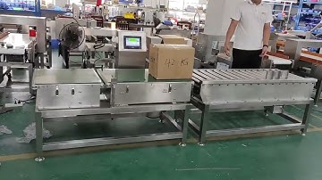 Checkweigher for boxes with roller type