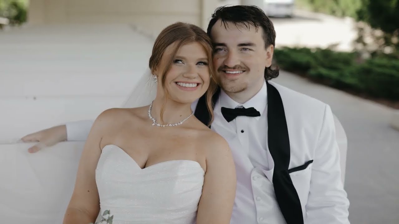 Bride and groom smiling together, the groom in a white jacket and bow tie, at Greystone Estate in Ball Ground, GA