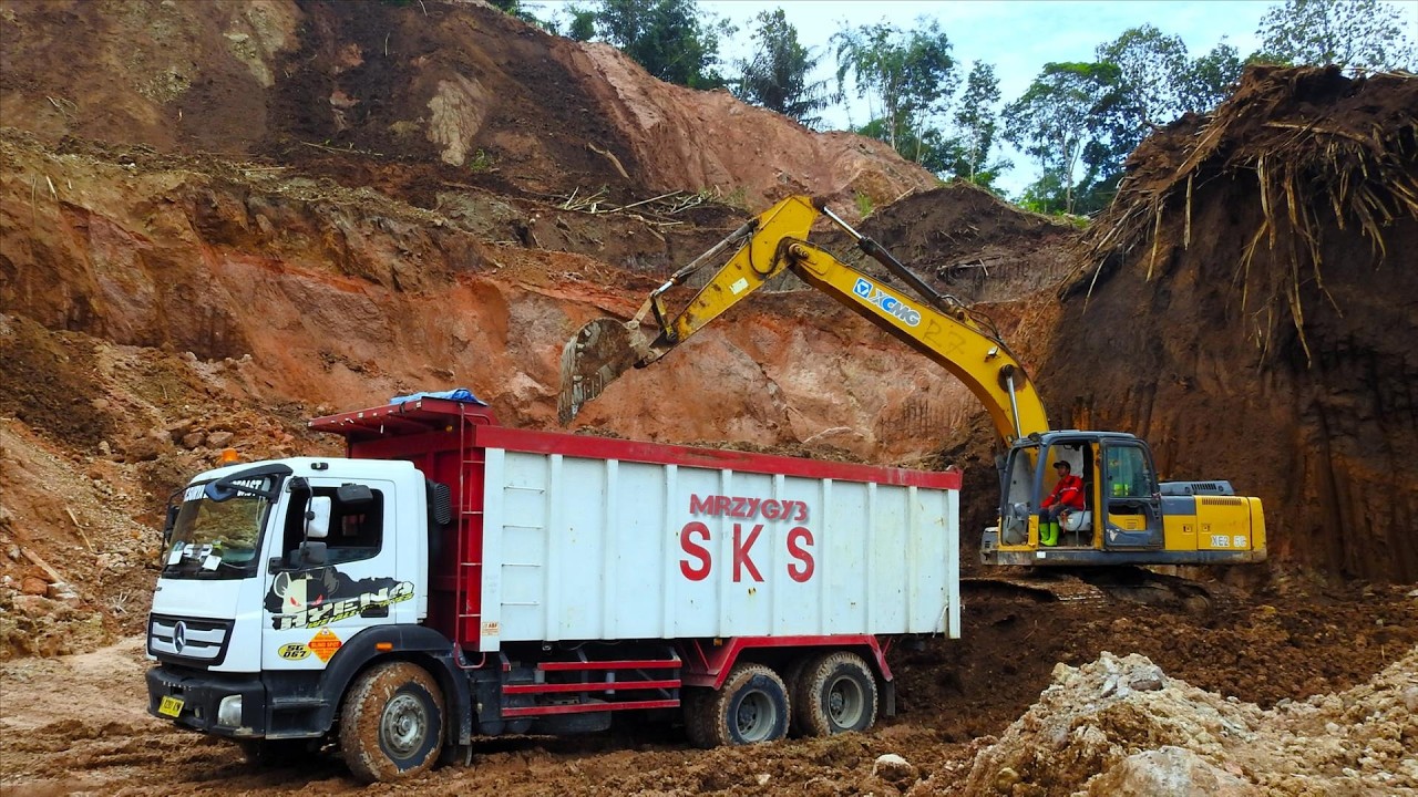 Process of the Excavator Loading Trucks for the Toll Road Construction ...