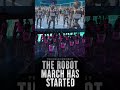 Dozens of humanoid robots moving in formation at the same time.