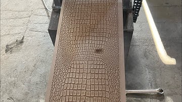 How does the embossing machine press crocodile patterns on the density board