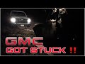 GMC Sierra 2500HD stuck in mud, pulled out by caterpillar skid steer