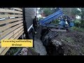 Excavating and installing drainage on house