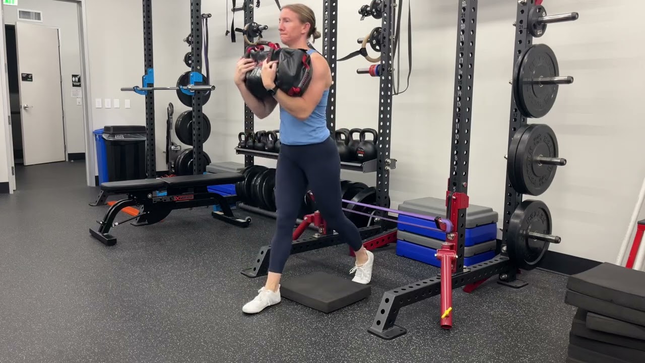 Stomp Split Squat with Sandbag Zercher Hold