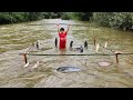 Bac used stakes and many bamboo trees to tie many fishing nets fishing for fish in flood season