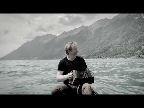 Cormac Begley playing an Irish slow air on a canoe in Switzerland