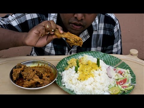Eating delicious chicken curry with rice & salad