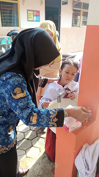 Membantu siswa yang sakit ketika upacara, Guru memberikan pertolongan pertama dengan ikhlas