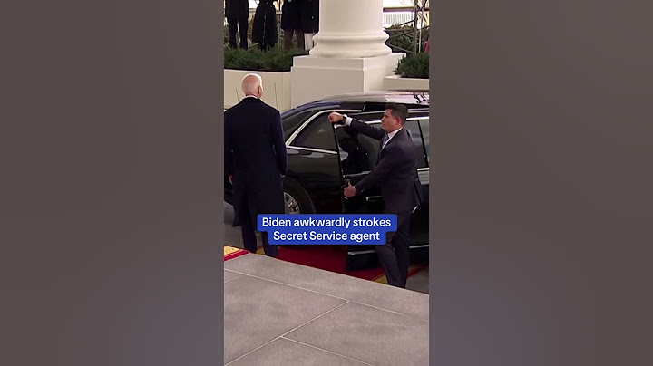 Biden awkwardly strokes Secret Service agent