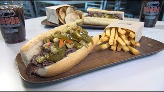 Putting all the ingredients together and taking one down, elliott
bambrough is getting his hands on an italian beef sandwich.