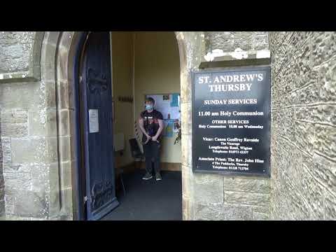 me ringing the bell of ST Andrews church in Thursby outside view