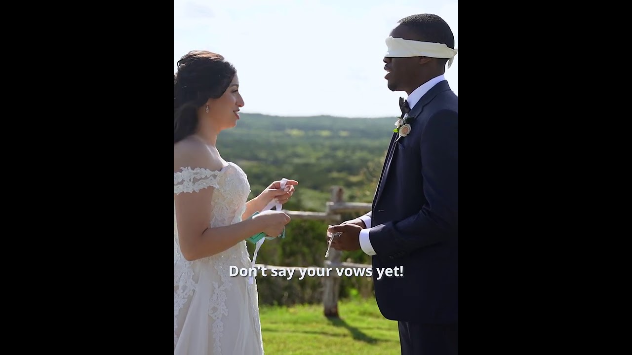 Bride and blindfolded groom giving each other gifts before their wedding.