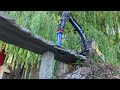 Demolition of an old road bridge with a model excavator