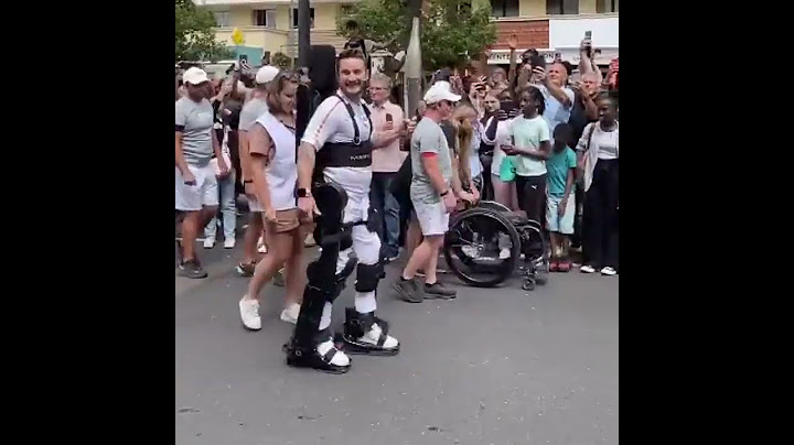 Paraplegic Athlete Kevin Piette Carries Olympic Flame Using Robotic Exoskeleton.