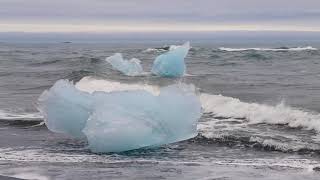 Iceberg on diamond beach, Glacier Lagoon, Iceland. Relaxing movements and sounds.