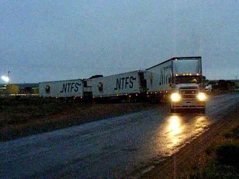 National Roadtrain Link (NRL) International Eagle Triple Road-Train pulls out of the Inglis Road-Train Terminal on Old Tarcoola Road at Port Augusta loaded for Coles in Alice Springs.