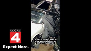 Car crashes through fence, lands on 2 parked cars