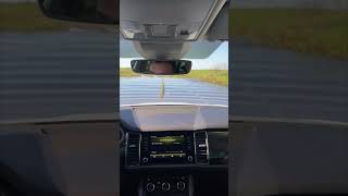 Vehicle Drives Through a Deep Puddle on a Muddy Rural Road