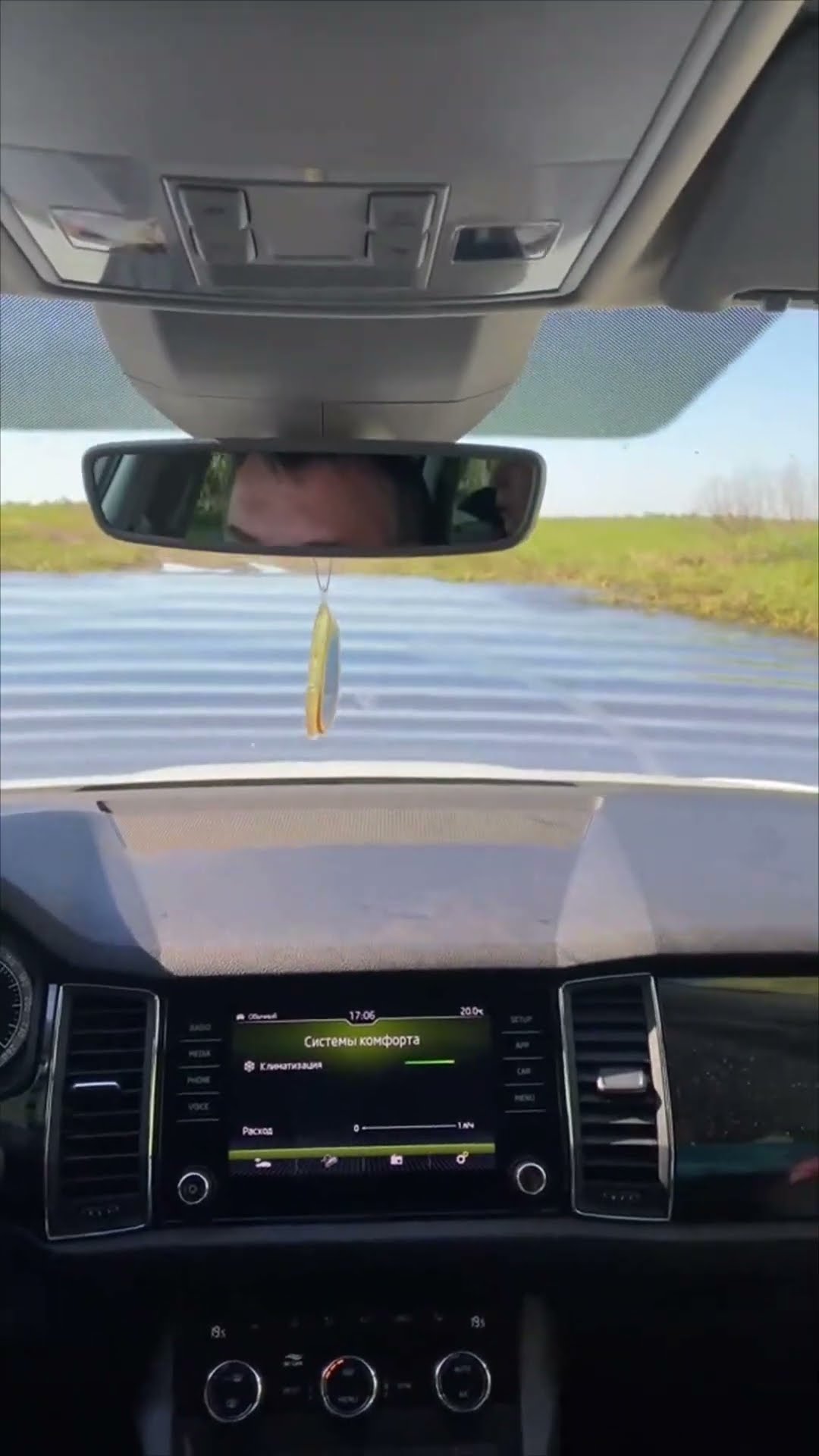 Vehicle Drives Through a Deep Puddle on a Muddy Rural Road