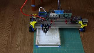 Rolling Plotter creating Flower of Life Design in pan of Baking Soda