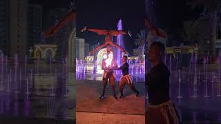 Guy Juggling Fire Clubs While Head Balancing Another
